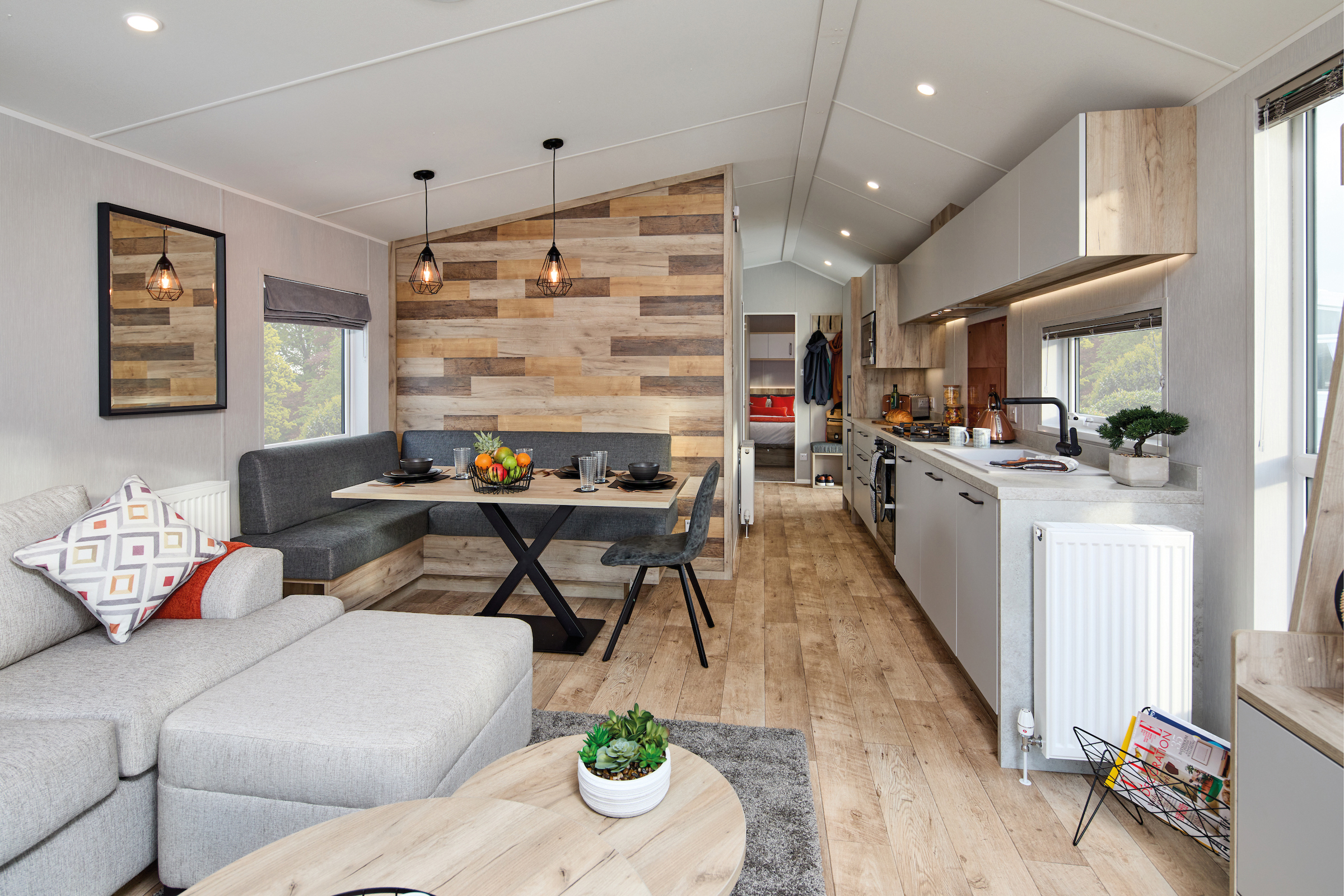 Interior of the Willerby Astoria holiday caravan showing a spacious open-plan kitchen and dinette with contemporary furnishings.